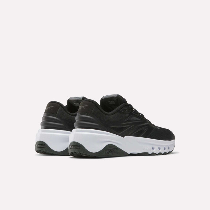 A pair of Reebok Men's ERS Training Shoes in black, featuring thick white soles and premium cushioning, displayed from the back and side on a plain white background.