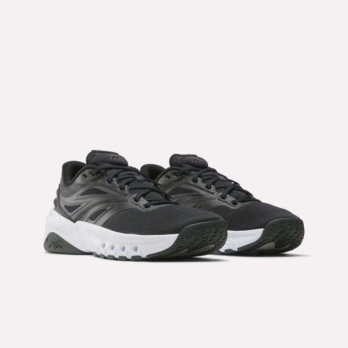 The Reebok Men's ERS Training Shoes feature a black design with white chunky soles, black laces, and a subtle side logo. These shoes provide premium cushioning and are shown on a plain light background.