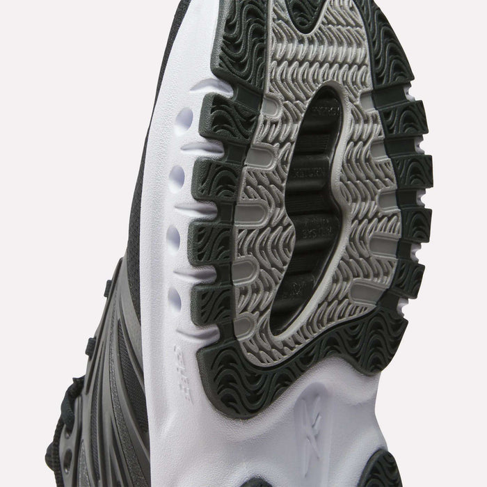 Close-up of the black and white sole on Reebok Men's ERS Training Shoes, showcasing detailed tread patterns and textured rubber for enhanced durability, traction, and superior cushioning during workouts.