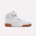 The Men's EX-O-FIT Hi Shoes by Reebok are white leather high-tops with a Velcro strap, blue and red Reebok branding, and a brown rubber sole, shown in side profile on a plain light background for a retro look.