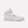 The Reebok Men's EX-O-FIT Hi Shoes feature white leather, a Velcro strap, blue and red classic branding, and a textured rubber sole. Shown in side profile against a plain light background.