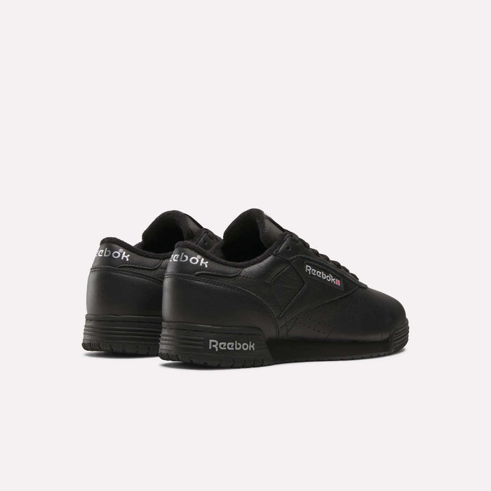 The Reebok Men's Exofit Lo Shoes are black low-top sneakers, shown from the back and side, displaying the Reebok logo in white and red on the side and heel against a plain white background.