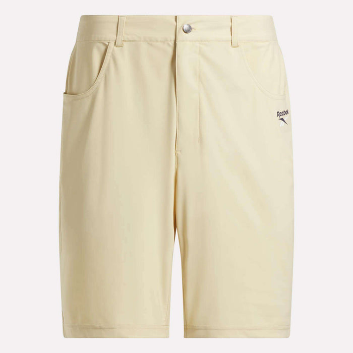 Reebok Men's Favorite 5-Pocket Golf Shorts 9" in light yellow feature front pockets, belt loops, a button closure, and the Reebok logo on the left pocket. Made from sweat-wicking fabric for a simple, athletic look.