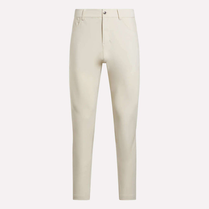 The Reebok Men's Favorite 5-Pocket Relaxed Fit Golf Pants, in light beige wrinkle-resistant fabric with belt loops, button closure, and front pockets, are shown against a plain white background.