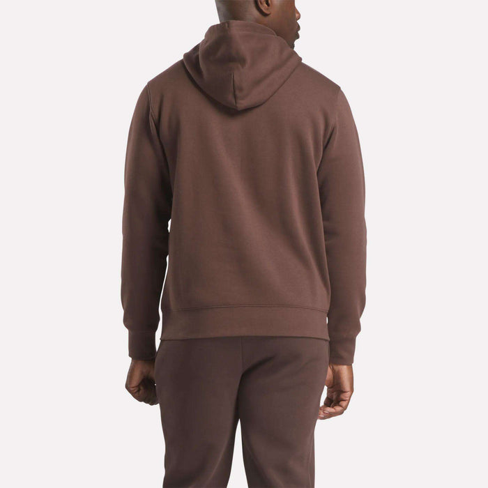 A man is shown from the back wearing the Reebok Men's Finisher Hoodie in brown with matching pants, standing against a plain light background.