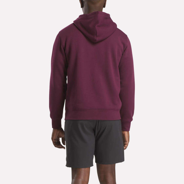 A man is seen from behind wearing the Reebok Men's Finisher Hoodie in maroon with black shorts, standing against a plain white background.