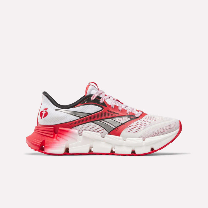 The Reebok Men's FloatZig 2 AHA Running Shoes feature a white upper with red and black accents, red laces, a gradient red and white sole, energy-returning cushioning, and a side logo, shown on a plain white background.