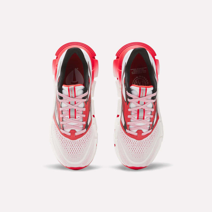 The Men's FloatZig 2 AHA Running Shoes by Reebok are shown from above, featuring white mesh uppers, energy-returning cushioning, red accents on the heel and toe, and white laces with red stripes against a light background.