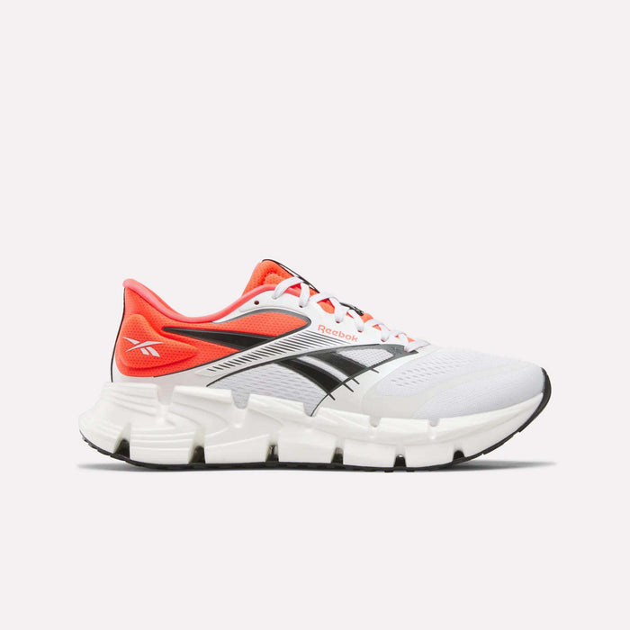 The Reebok Men's FloatZig 2 Running Shoes feature a supportive upper with black and red accents, a black logo, red heel and tongue, white laces, and a thick segmented white sole with Superfloat+ cushioning in White/Red/Black.