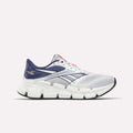 The Reebok Men's FloatZig 2 Running Shoes feature a white and navy mesh upper, Superfloat+ cushioning, thick segmented white sole, navy and black accents, and Reebok logos on the heel and side.