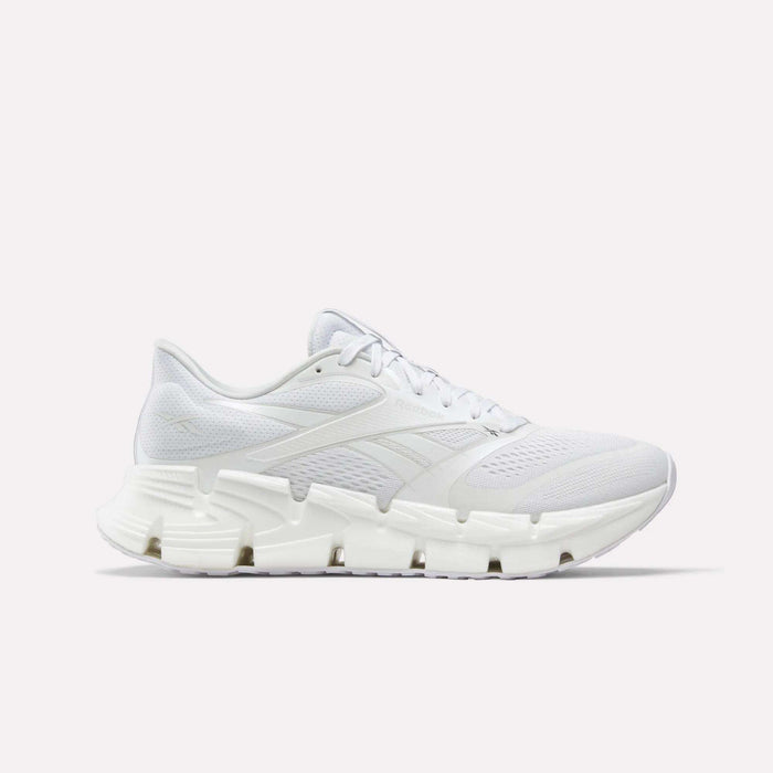 The Reebok Men's FloatZig 2 Running Shoes feature a white mesh upper, detailed side panels, and a thick sculpted sole with energy-returning cushioning, shown against a plain white background.