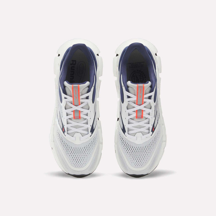 Top view of a pair of Reebok Men's FloatZig 2 Running Shoes with white mesh toes, navy interiors, Superfloat+ cushioning, and orange tongue branding, displayed side by side on a plain white background.