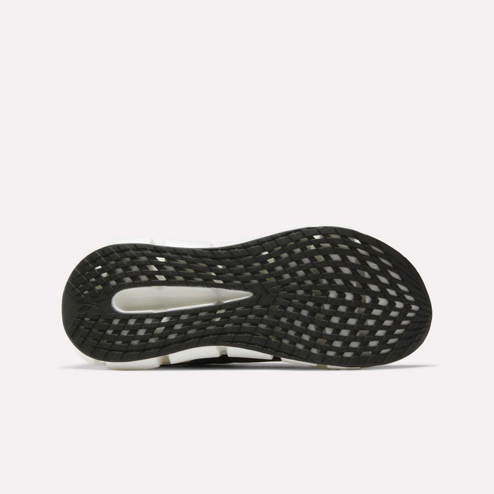 Close-up of the black, white, and gray sole on Reebok Men's FloatZig 2 Running Shoes, showing a textured grid tread pattern and Superfloat+ cushioning, set against a plain white background.