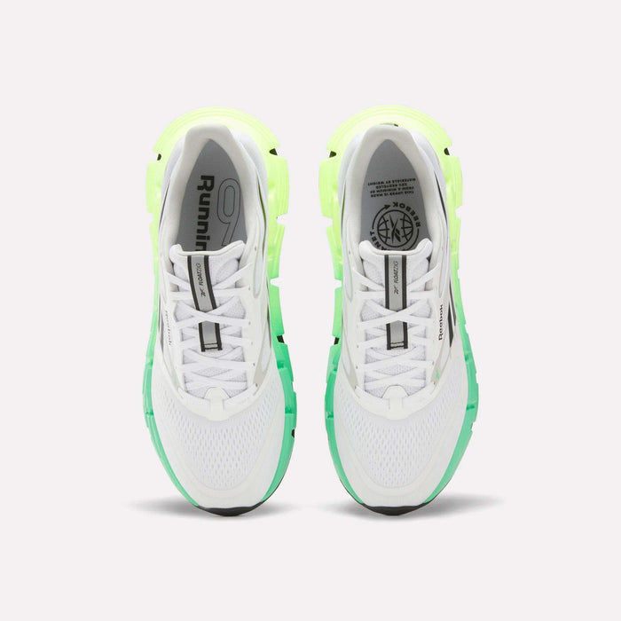 A top view of Reebok Men's FloatZig 2 Running Shoes in white with light green and neon yellow accents, Superfloat+ cushioning, black soles, and branding on the tongues and insoles, set against a plain white background.