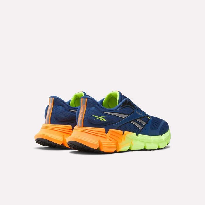 The Men's FloatZig 2 Running Shoes by Reebok in blue feature neon green and bright orange chunky soles with Superfloat+ cushioning, shown from the back and side on a plain white background.