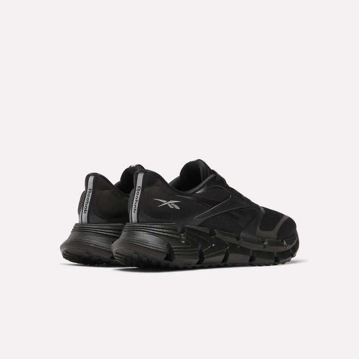 A pair of Reebok Men's FloatZig 2 Running Shoes in black with thick, energy-returning cushioning soles and bold logos, positioned side by side at an angle on a plain white background.