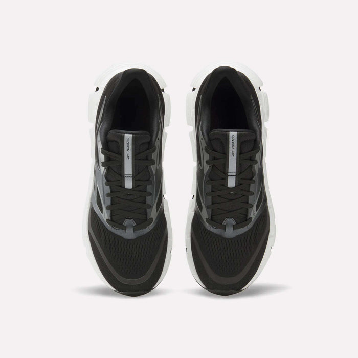 The Reebok Men's FloatZig 2 Running Shoes feature a black design with white soles, gray accents, black laces, mesh toe detailing, and Superfloat+ cushioning. Shown from above against a plain white background.