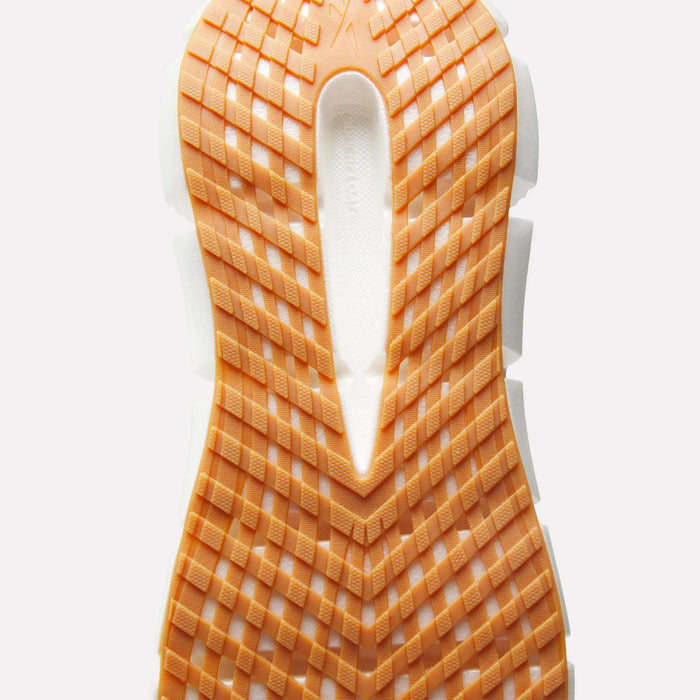 Close-up of the Reebok Men's FloatZig 2 Running Shoes sole, showcasing Superfloat+ cushioning, a grid-like tread pattern, and a white groove running vertically through the center.