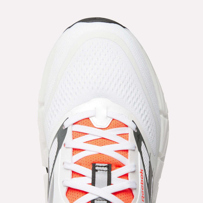 Top view close-up of Men's Reebok FloatZig 2 Running Shoes with orange accents, white laces, mesh upper, supportive design, and small logo by the laces. Features Superfloat+ cushioning for comfort.