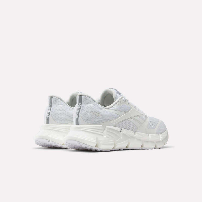 A pair of white Men's FloatZig 2 Running Shoes by Reebok featuring energy-returning cushioning.