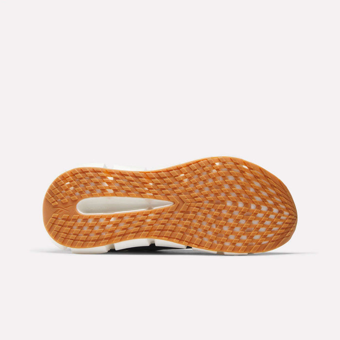 The image shows the underside of the Reebok Men's FloatZig 2 Running Shoes with a light brown gum sole and textured diamond-patterned tread. The running shoe features Superfloat+ cushioning against a plain white background.