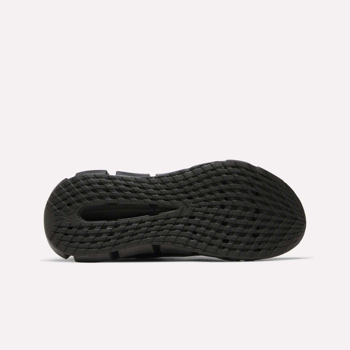 The image shows the bottom view of a black Reebok Men's FloatZig 2 Running Shoe outsole with a grid-like textured tread for grip and energy-returning cushioning, all set against a plain white background.
