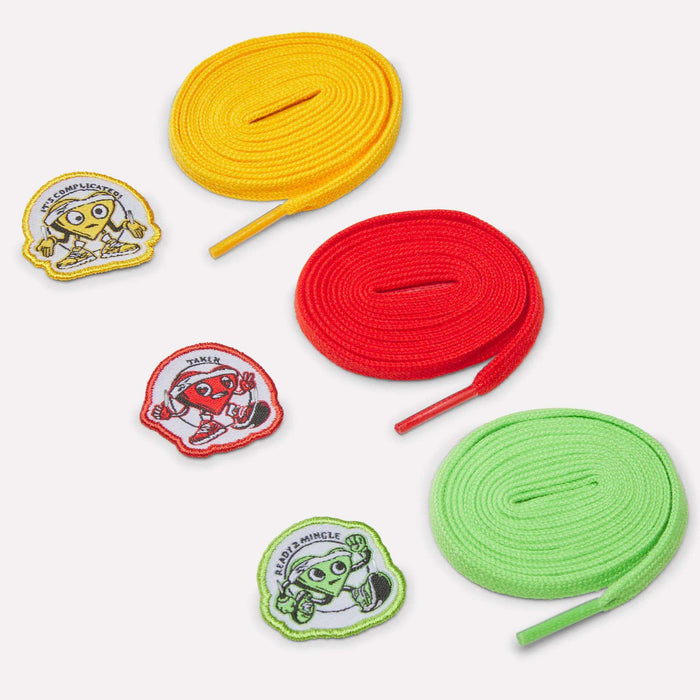 Three rolled shoelaces in yellow, red, and green, each with a matching embroidered cartoon patch—ideal for customizing your Reebok Men's FloatZig 2 SoleMates Running Shoes. All items are arranged on a white background.