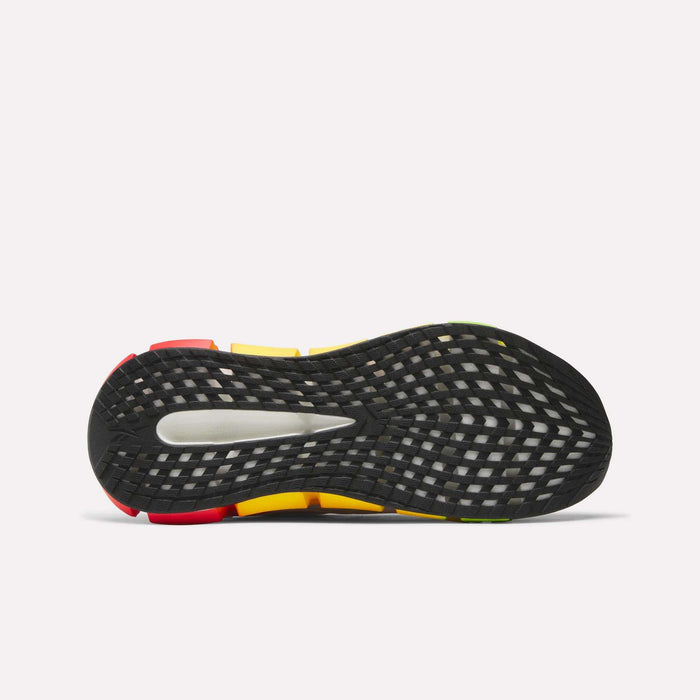 The image shows the bottom view of Reebok Men's FloatZig 2 SoleMates Running Shoes, with a black rubber outsole featuring a grid-like pattern and red, yellow, and green accents, plus a lightweight foam midsole for performance running.