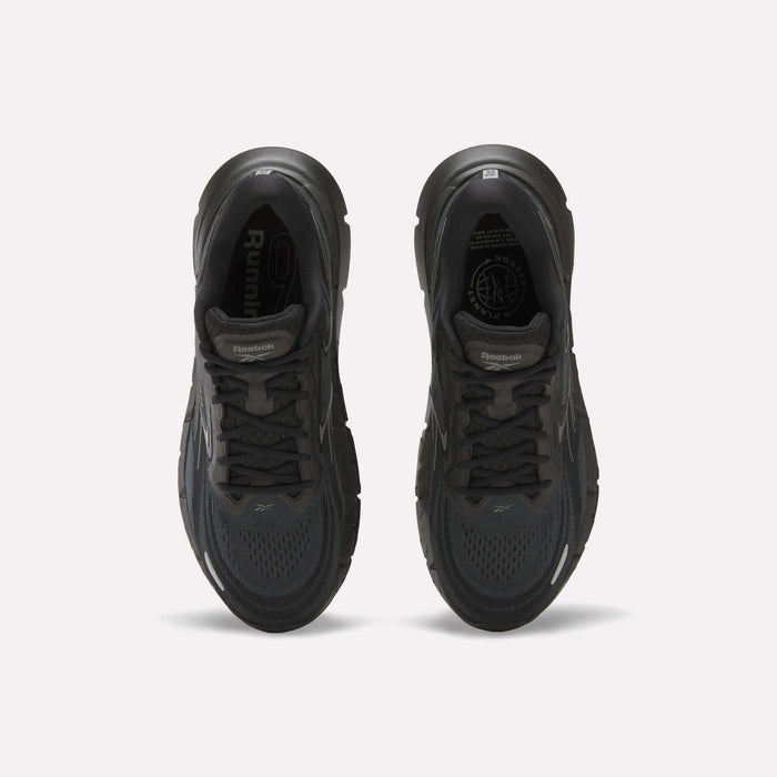 Top view of a pair of Reebok Men's FloatZig Double Running Shoes in black, featuring cushioned soles, dark laces, and mesh uppers, displayed side by side on a plain white background.