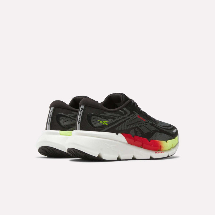 A pair of Reebok Men's FloatZig Double Running Shoes in black with a thick white sole and red, yellow, and green gradient midsole accents. The cushioned athletic sneakers are angled to display the back and side.