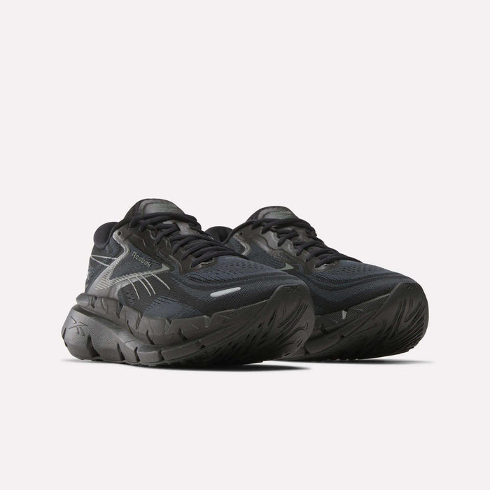 A pair of Reebok Men's FloatZig Double Running Shoes in black with thick, textured soles and silver accents for max-cushioned miles, displayed on a plain white background.