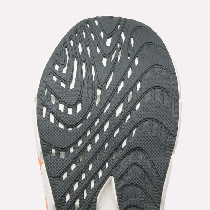 Close-up of a Reebok Men's FloatZig Double Running Shoe sole, showing its textured rubber with wavy grooves for traction—ideal for max-cushioned runs—all set against a plain, light background.
