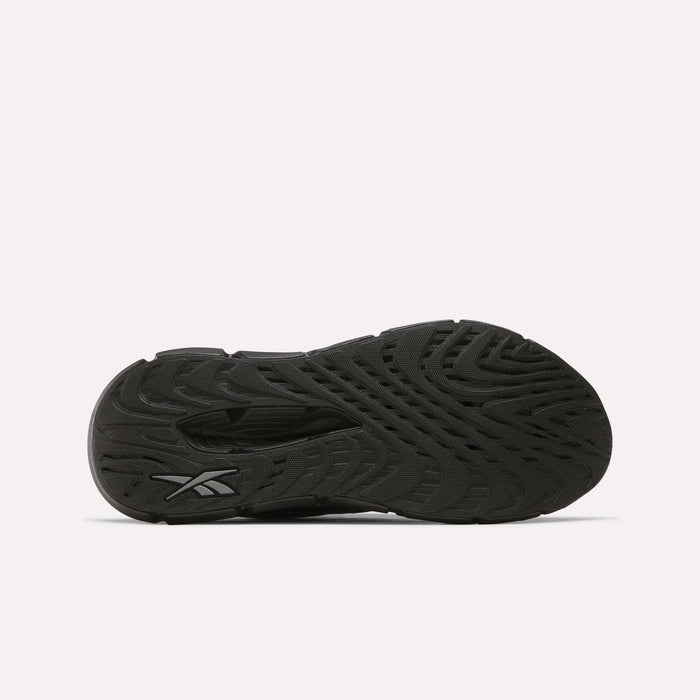 The image displays the black, textured sole of Reebok Men's FloatZig Double Running Shoes from below against a white background. The wavy grooves provide traction, with a Reebok logo visible near the heel.