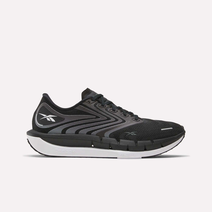 The Reebok Men's FloatZig Tread Running Shoes feature a black and gray design with a white sole, black laces, and a cushioned midsole, ideal for treadmill workouts. The Reebok logo is on the side against a plain white background.