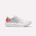 The Reebok Men's FloatZig Tread Running Shoes are white with gray and red accents, a mesh upper, wavy gray sides, red logos, and a thick cushioned midsole—ideal for treadmill workouts.