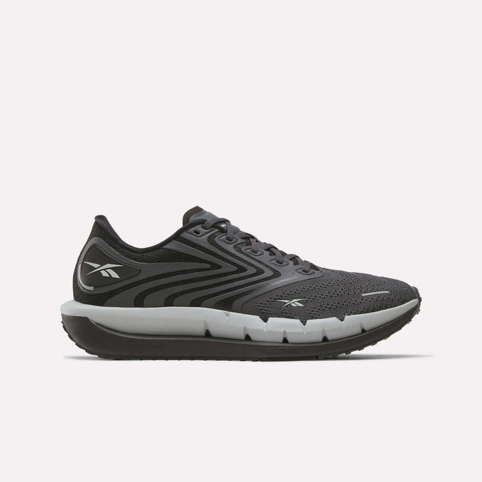 The Reebok Men's FloatZig Tread Running Shoes in black and gray feature a mesh upper, lace-up closure, thick cushioned midsole for comfort during treadmill workouts, and display the Reebok logo on the heel and side.
