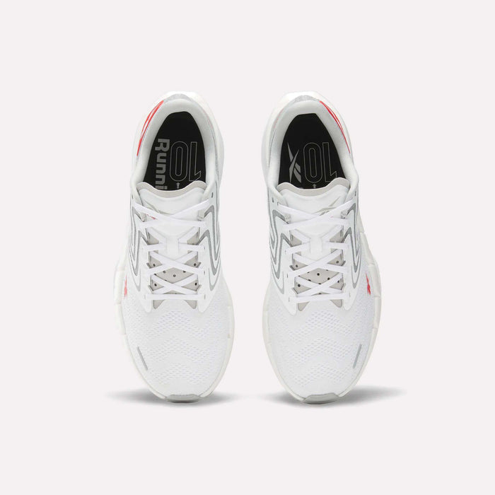 A pair of Men's FloatZig Tread Running Shoes by Reebok in white with gray and red accents, viewed from above, show the tops, laces, cushioned midsole, and "Running" text on black insoles—ideal for treadmill workouts.