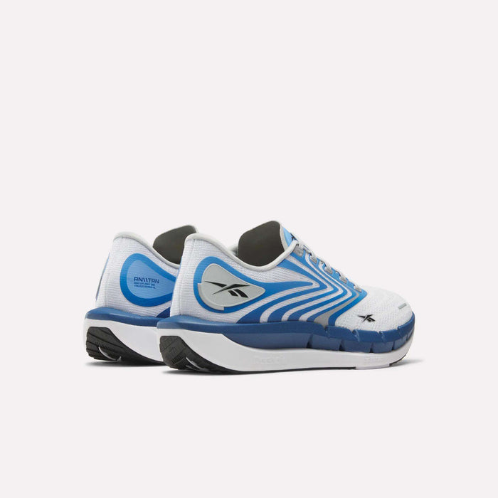 The Reebok Men's FloatZig Tread Running Shoes in white and blue feature black soles, a sleek modern design, and the Reebok logo—viewed from the back left side—ideal for treadmill workouts with their dual-density midsole.