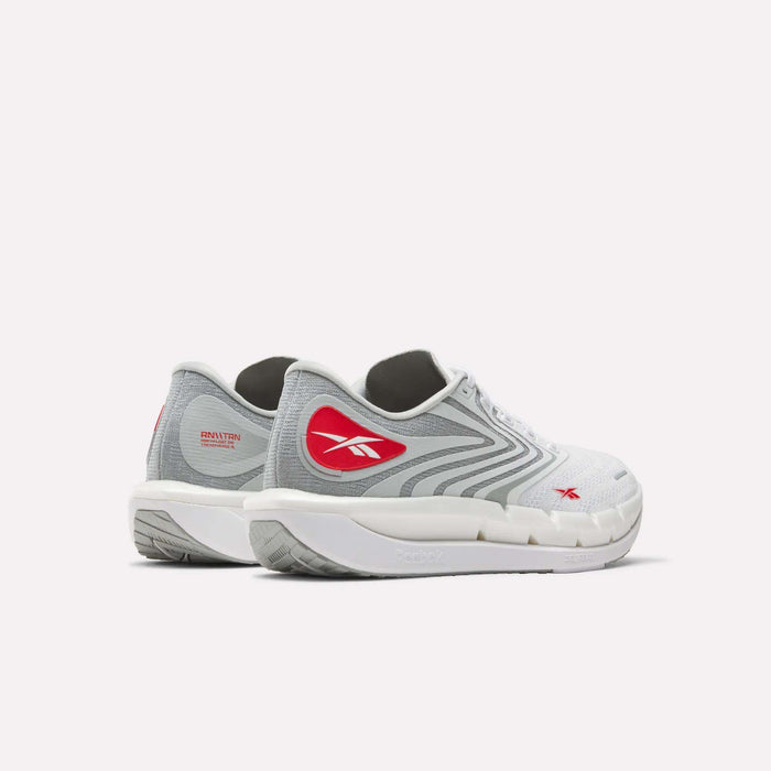 The Reebok Men's FloatZig Tread Running Shoes come in white and light gray with red accents, including the logo on the side and heel. They feature cushioned midsoles, white soles, black interiors, and are ideal for treadmill workouts.