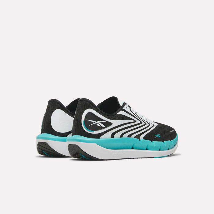 The Reebok Men's FloatZig Tread Running Shoes in black, white, and turquoise feature a wavy pattern and cushioned midsole—shown from a rear-side angle on a plain white background—perfect for treadmill workouts.