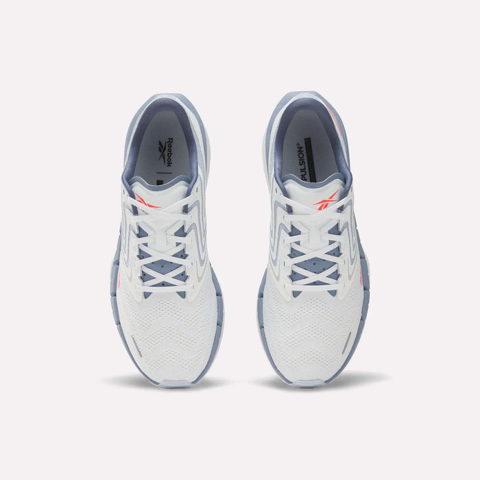 A pair of Reebok Men's FloatZig Tread Running Shoes in white with light blue accents viewed from above, highlighting the laces, mesh upper, and Reebok logo—perfect for treadmill workouts.