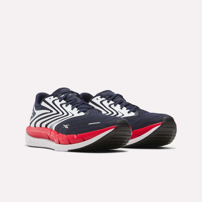 Men's Reebok FloatZig Tread Running Shoes in navy blue with white zig-zag patterns, red midsoles, and black outsoles, ideal for treadmill workouts, shown against a plain white background.