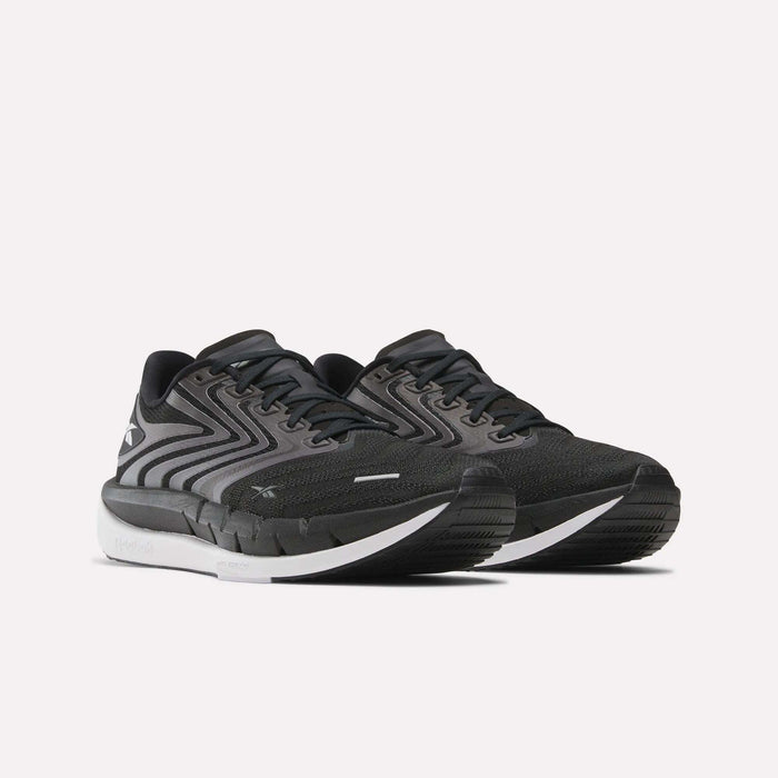 A pair of Reebok Men's FloatZig Tread Running Shoes in black with a cushioned midsole, ideal for treadmill workouts.