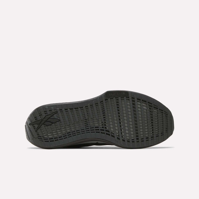 The image displays the black rubber outsole of Reebok Men's FloatZig Tread Running Shoes, featuring a grid-like tread and subtle heel logo for grip and durability during treadmill workouts. The background is plain white.