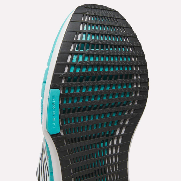 Close-up of the sole on Reebok Men's FloatZig Tread Running Shoes, featuring a black grid-like tread, turquoise accents, cushioned midsole, and GRIPTONIC label—ideal for treadmill workouts.