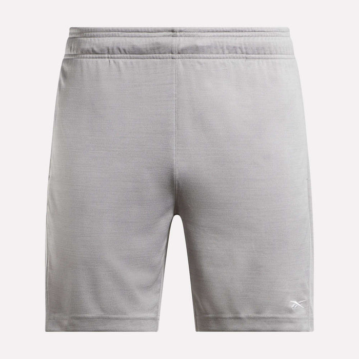 The Reebok Men's Inclination Shorts feature an elastic waistband and a white logo on the lower left leg, shown from the back in light gray—a versatile choice for men's workouts.