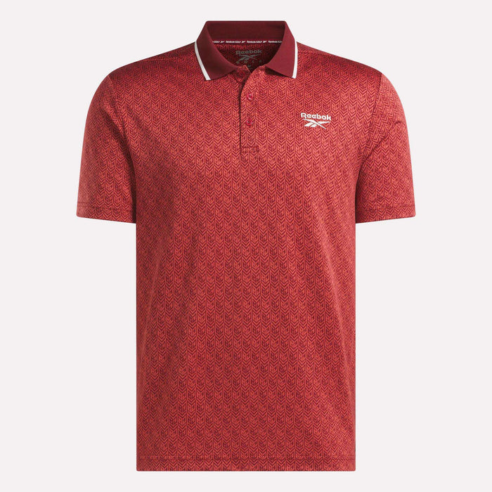 Men's Jacquard Polo Shirt by Reebok in red, featuring a subtle geometric jacquard pattern, short sleeves, and a classic collar with stylish white trim. Finished with the white Reebok logo on the left chest.