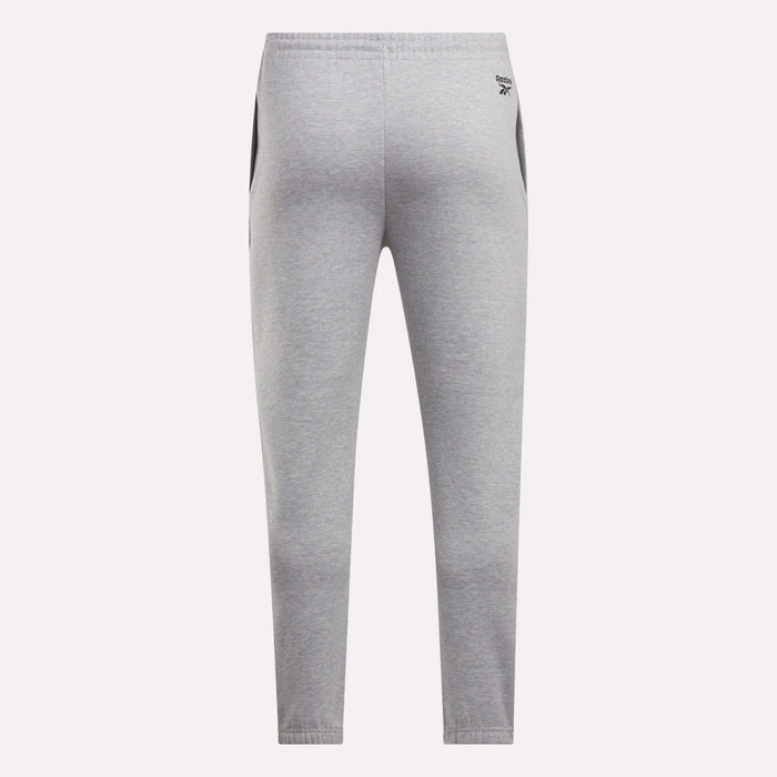 Back view of Reebok Men's Joggers in light gray with black side panels, elastic waistband, and a small logo on the left hip, shown against a plain white background.
