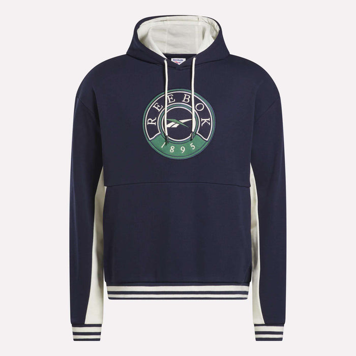 The Men's Lawn Club French Terry Hoodie by Reebok is navy blue with a soft cotton blend, white drawstring, white side and hood accents, and a large circular green, white, and navy Reebok 1895 logo on the chest.