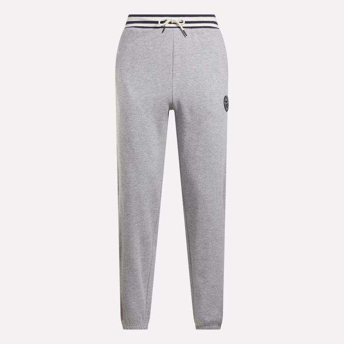 Reebok Men's Lawn Club French Terry Jogger Pants in light gray feature a cotton-blend fabric, navy striped drawstring waistband, straight legs, and a small circular logo on the left thigh. Stylish everyday sporty comfort. Shown on a white background.
